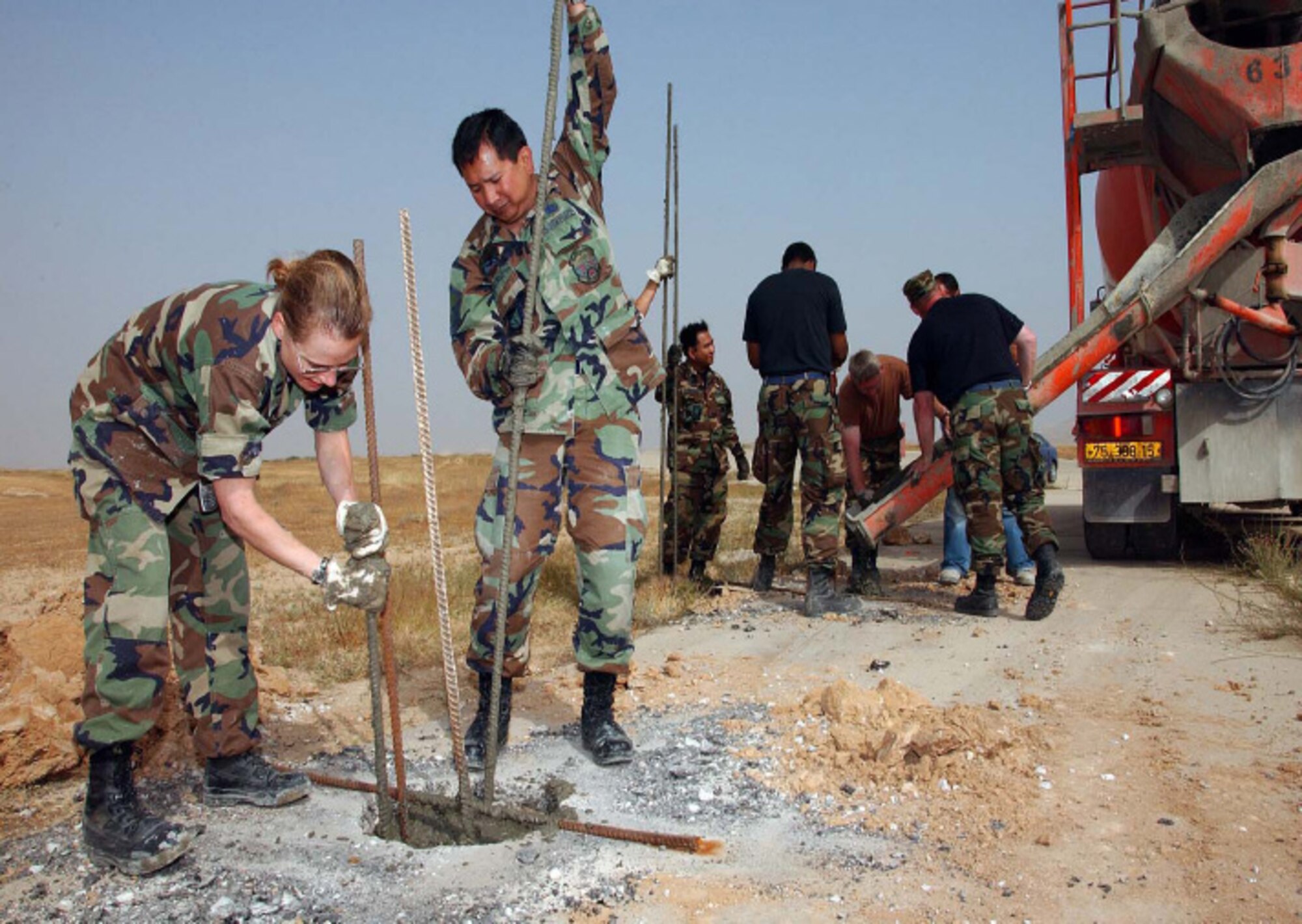 Capt. Kerrigan and MSgt. Jun Galvez, operations manager, help prepare the foundation for a sun shade, a dome to shelter Israeli Air Force F-16s from the desert heat. Photo by Master Sgt. Julia Barklow