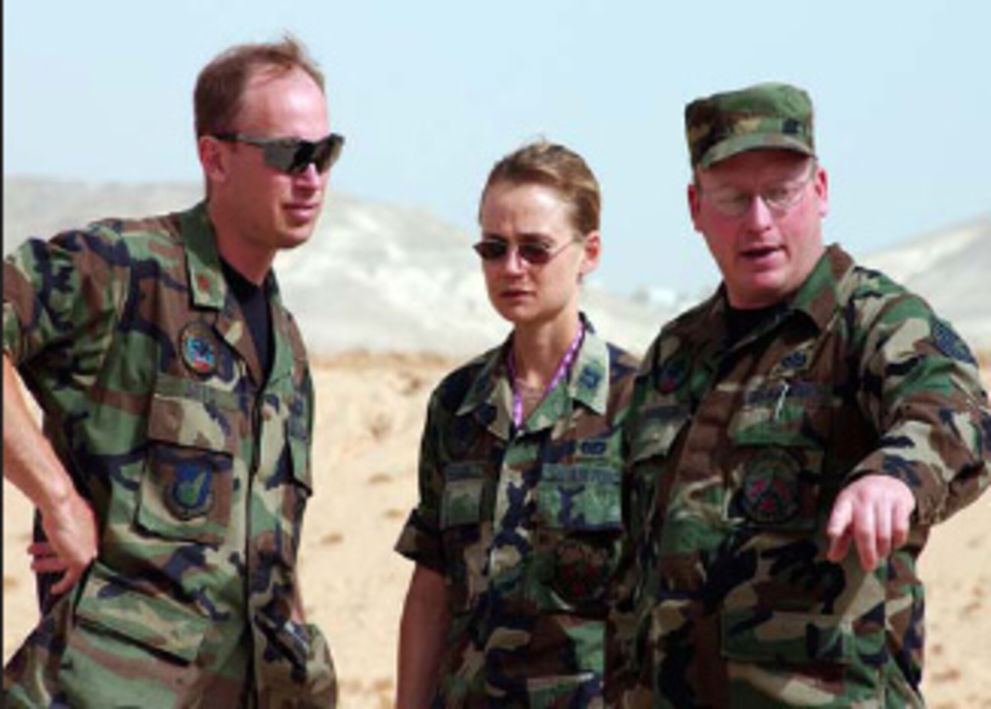 Maj. Ed Soto (left), the deployment commander, studies a work site with Capt. Stephanie Kerrigan and TSgt. Robert Anderson. Photo by Master Sgt. Julia Barklow.