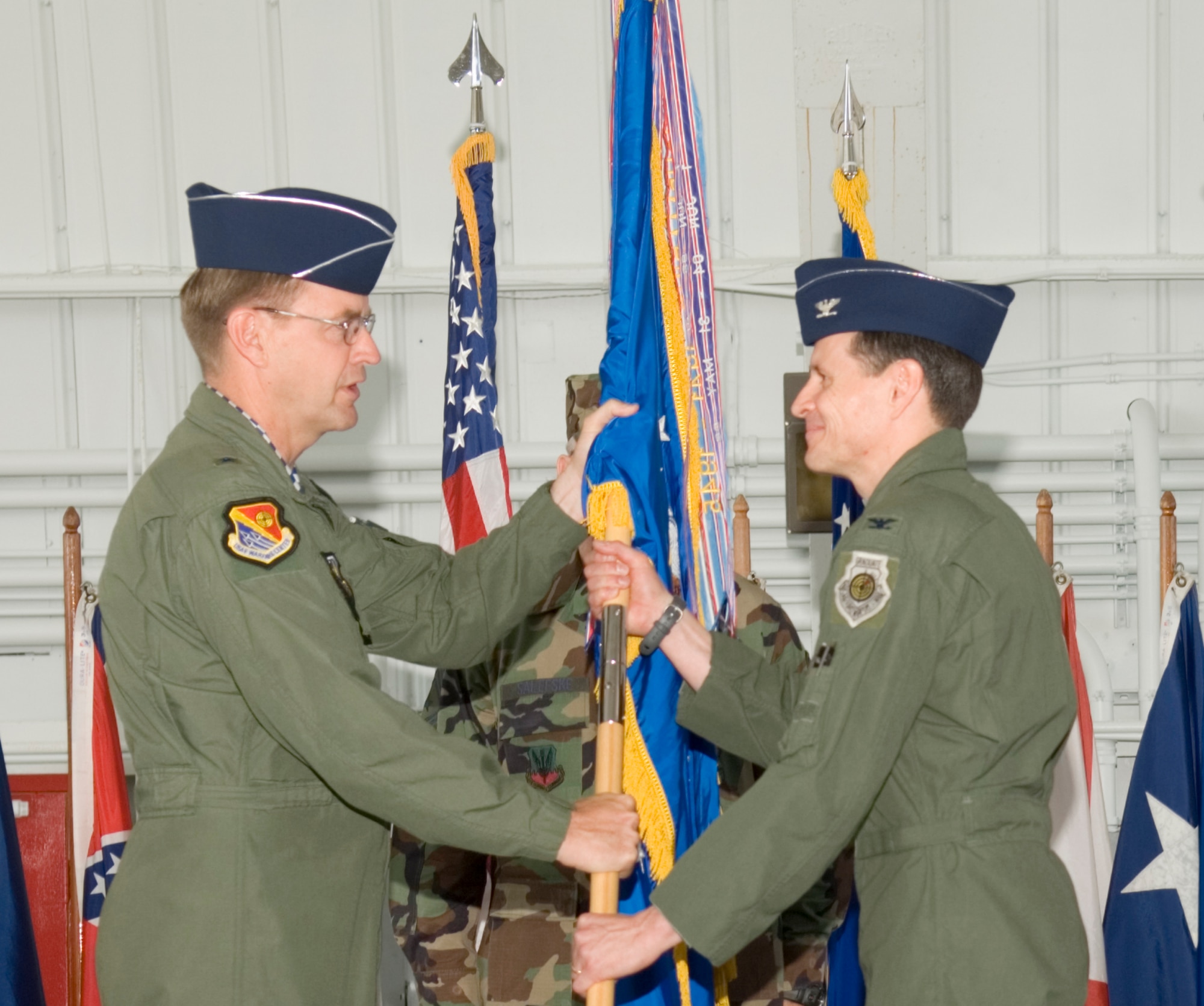 Col. Steve DePalmer accepts the 53d Wing guidon from Brig. Gen. Stephen Hoog, United States Air Force Warfare Center commander, during the wing's change of command ceremony April 11 at Eglin Air Force Base, Fla.  Colonel DePalmer assumed command of the wing from Col. Ken Wilsbach.  Air Force photo by Debbie Haussermann.