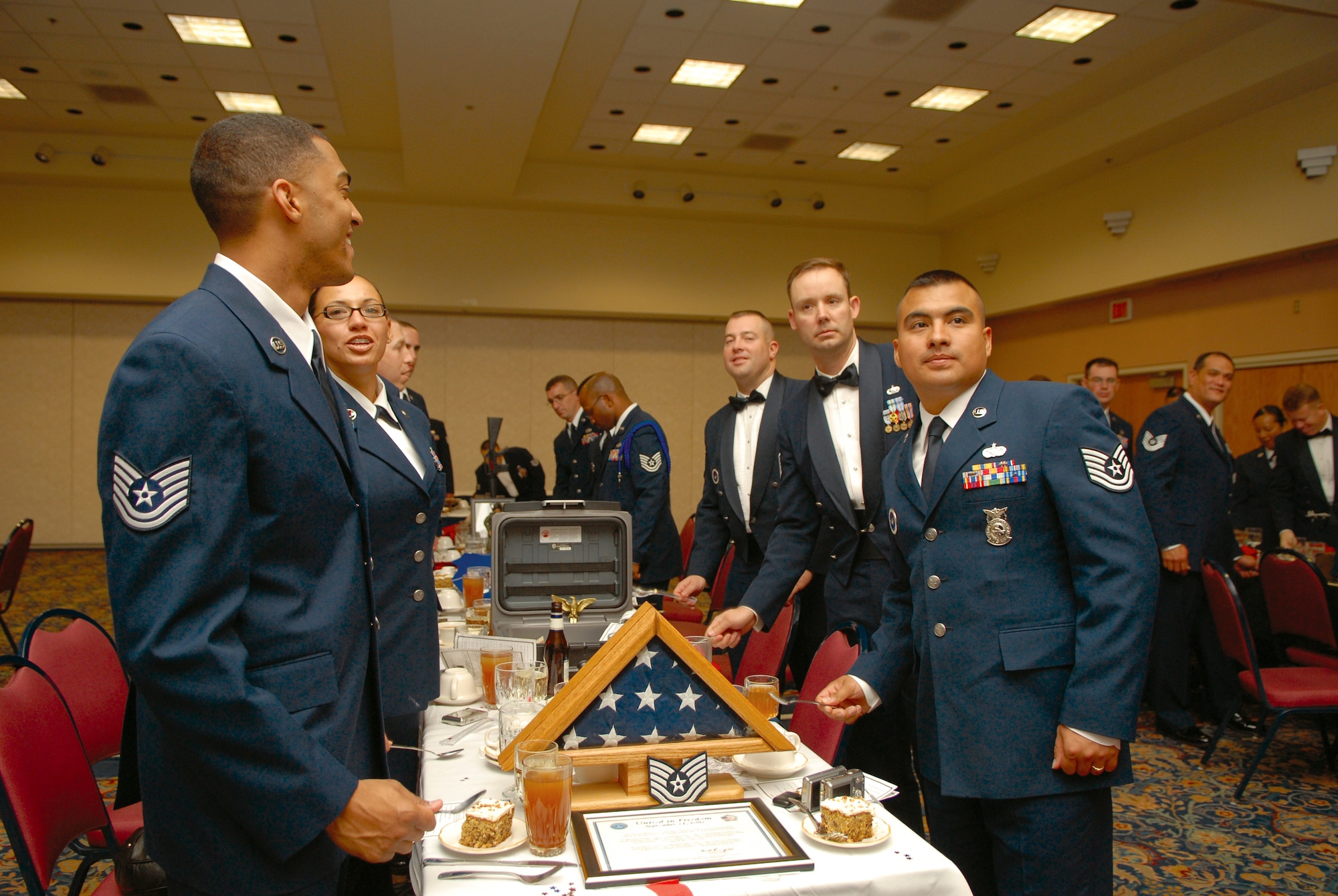 Attendees at the Goodfellow NCO Academy Dining-In show their enthusiasm. Applause is strictly forbidden in the Mess, and so displays of appreciation and enthusiasm are shown by the banging of spoons. (U.S. Air Force photo by Tech. Sgt. Gina O’Bryan)