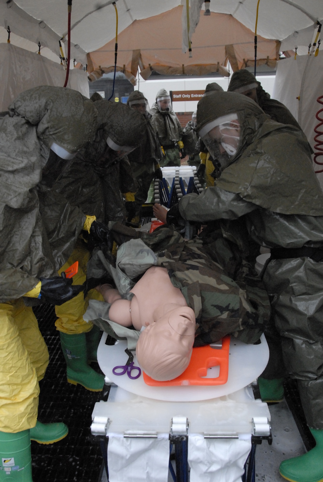 HANSCOM AFB, Mass – Personnel from the 66th Medical Group’s newly functional In-Place Patient Decontamination Unit practice decontamination procedures April 4 during a training session here. In the event of a chemical, biological, radiological, nuclear and high-yield explosive (CBRNE) weapons attack, the 20-person team is required to setup their TVI water heater, a tent and a hazardous material containment bladder to respond to affected personnel. The team decontaminates patients prior to bringing them into the medical facility in order to prevent contamination of health care providers or the medical treatment facility. (U.S. Air Force photo by 1st Lt. Geoff Buteau.)