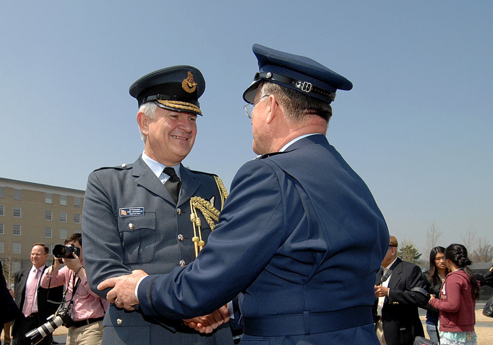 Royal Air Force Air Commodore Phil Goodman shakes hands with Lt. Gen. John A. Bradley during a ceremony honoring the 30,000 American Airmen who gave their lives flying from British bases during World War II April 10 at the Air Force Memorial in Arlington, Va. The event was arranged by the American Air Museum at Duxford, England, which is celebrating its 10th anniversary. The first Americans to serve in England were based at Duxford in 1918. During World War II it was also home to the 78th Fighter Group from 1943 to 1945. Former British Prime Minister John Major served as guest of honor for the ceremony. General Bradley is the chief of the Air Force Reserve. (U.S. Air Force photo/Andy Morataya) 