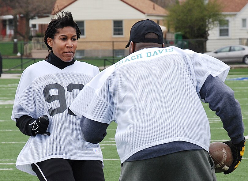 Wide receiver Robyn Bradford, a student researcher at the 711th Human Performance Wing's Human Effectiveness Directorate, works out against Dayton Diamonds defensive coordinator Jonathan Davis III at Roush Stadium in Kettering on April 11. (Photo by Chris Gulliford AFRL/RH)
