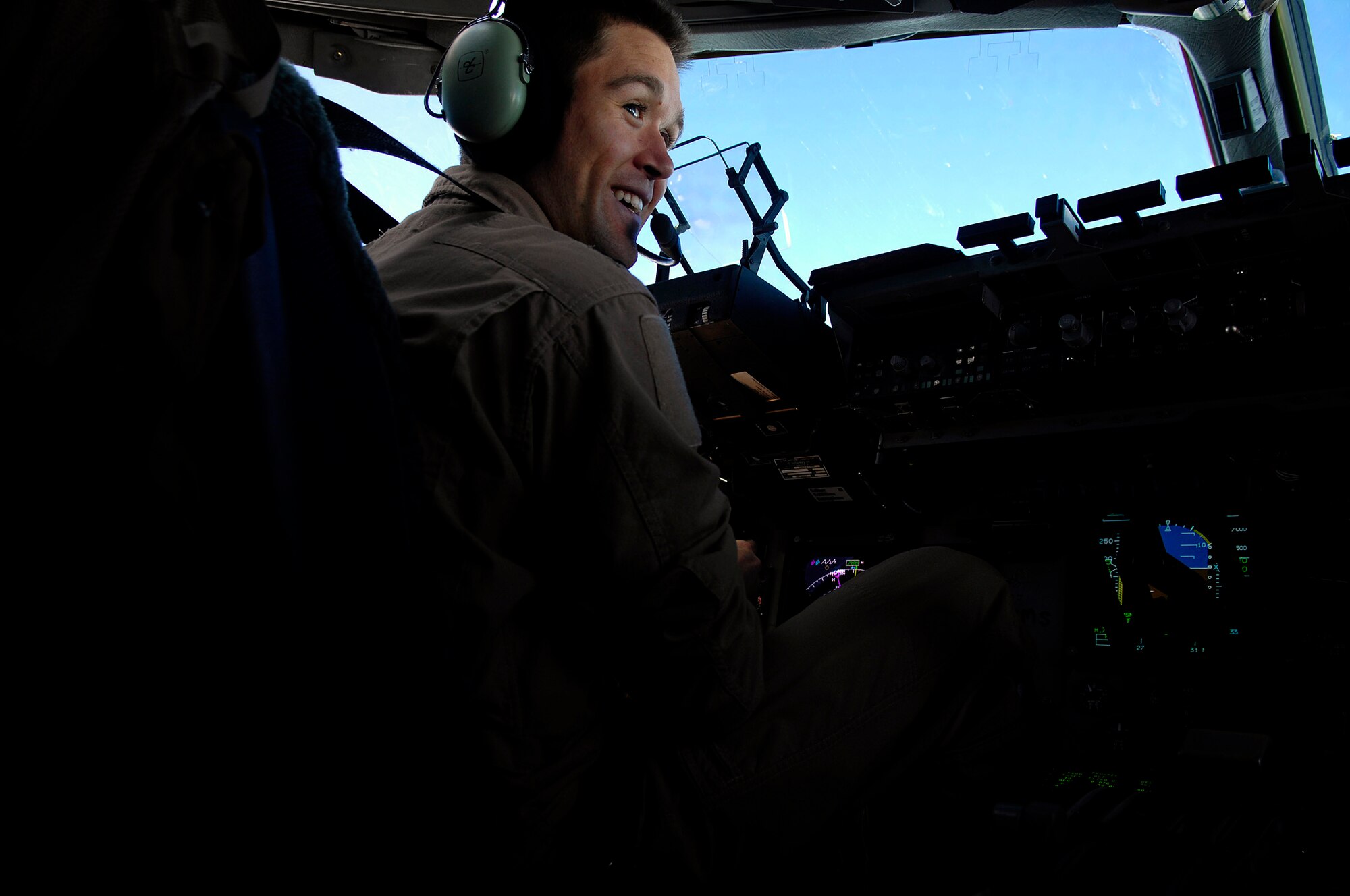 U.S. Air Force Capt. Erik Rathke talks to his copilot prior to the delivery of 40 bundles using the Joint Precision Airdrop Delivery System of humanitarian supplies to a drop zone in Afghanistan, Apr., 13, 2008. Rathke is a pilot from the 17th Airlift Squadron Charleston Air Force Base S.C., and is deployed to the 816th Expeditionary Airlift Squadron in Southwest Asia. (U.S. Air Force photo by Master Sgt. Andy Dunaway) (Released)
