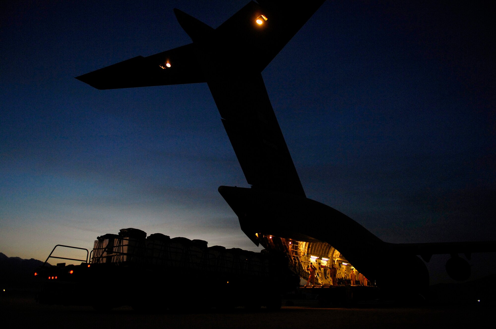 A U.S. Air Force C-17 Globemaster III is being loaded with 40 bundles for a Joint Precision Airdrop Delivery System of humanitarian supplies in Bagram Air Base, Afghanistan to a drop zone in Afghanistan, Apr., 13, 2008. Aircrew Airmen and the C-17 are deployed to the 816th Expeditionary Airlift Squadron in Southwest Asia. (U.S. Air Force photo by Master Sgt. Andy Dunaway) (Released)
