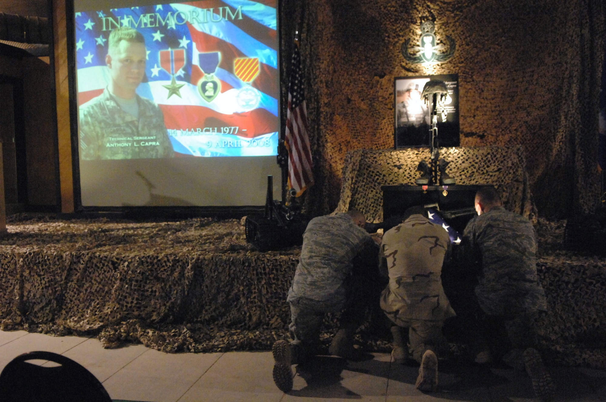 BALAD AIR BASE, Iraq -- Airmen remember their fallen comrade, Tech. Sgt. Anthony Capra, during a memorial service April 12, here.  Tech. Sgt. Anthony Capra, was a 332nd Expeditionary Civil Engineer Squadron Explosive Ordnance Disposal technician, who died in support of combat operations April 9. Sergeant Capra was posthumously awarded a Bronze Star, first Oak Leaf Cluster, for his heroic actions during his deployment. According to his medal citation, Sergeant Capra?s actions ensured the safety and freedom of movement for more than 41,000 coalition forces, multi-national contractors and local nationals. He contributed to the recovery and destruction of more than 24,000 pieces of ordnance weighing more than 26,000 pounds. Sergeant Capra was deployed from Indian Head Naval Ordnance Station, Md., Detachment 63. (U.S. Air Force photo/ Senior Airman Julianne Showalter.)
