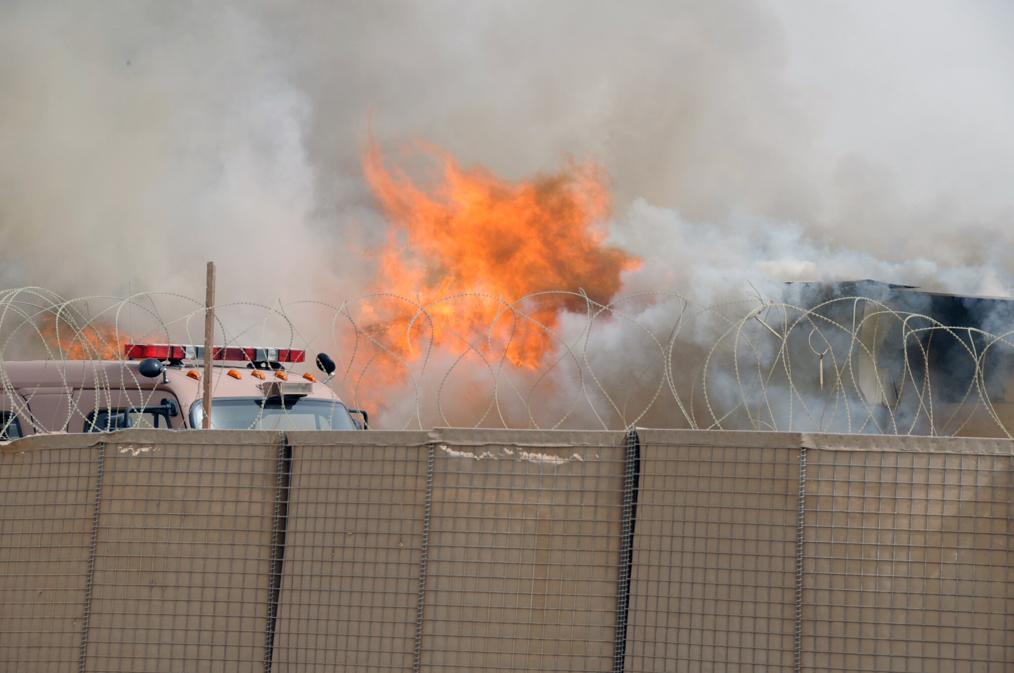 ALI BASE, Iraq -- The 407th Expeditionary Civil Engineering Squadron fire fighters repond to a blazing building in the Romanian camp here April 11.  The Air force emergency response forces respond to all emergencies here including coalition partners, such as the Romanians, or other services, like the U.S. Army and Navy. (U. S. Air Force photo / Tech. Sgt. Sabrina Johnson)