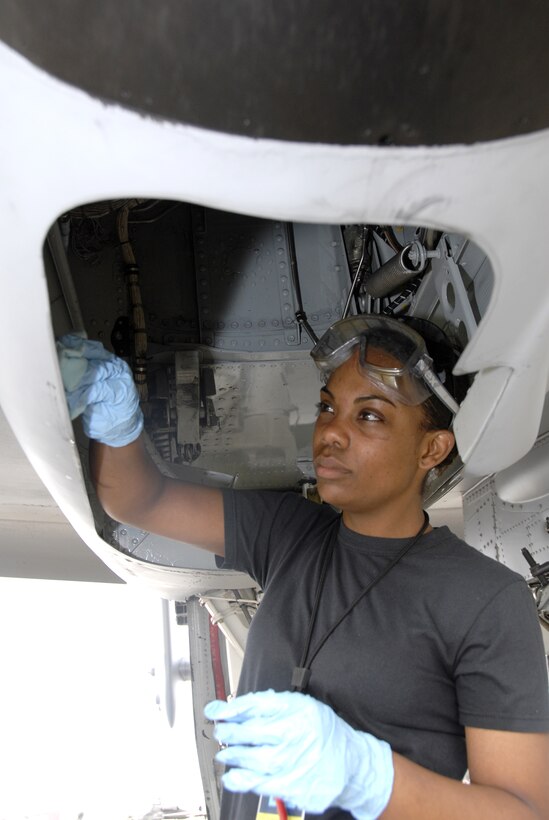 WHITEMAN AIR FORCE BASE, Mo. -- With an eye toward keeping her aircraft in top condition both inside and out, Airman 1st Class Samantha Lane, a 442nd Aircraft Maintenance Squadron crew chief, wipes up excess oil residue and dirt inside an A-10 Thunderbolt II wheel well. As a crew chief Airman Lane helps ensure the aircraft are always mission ready. The 442nd AMXS is part of the 442nd Fighter Wing, an Air Force Reserve Command unit based here.