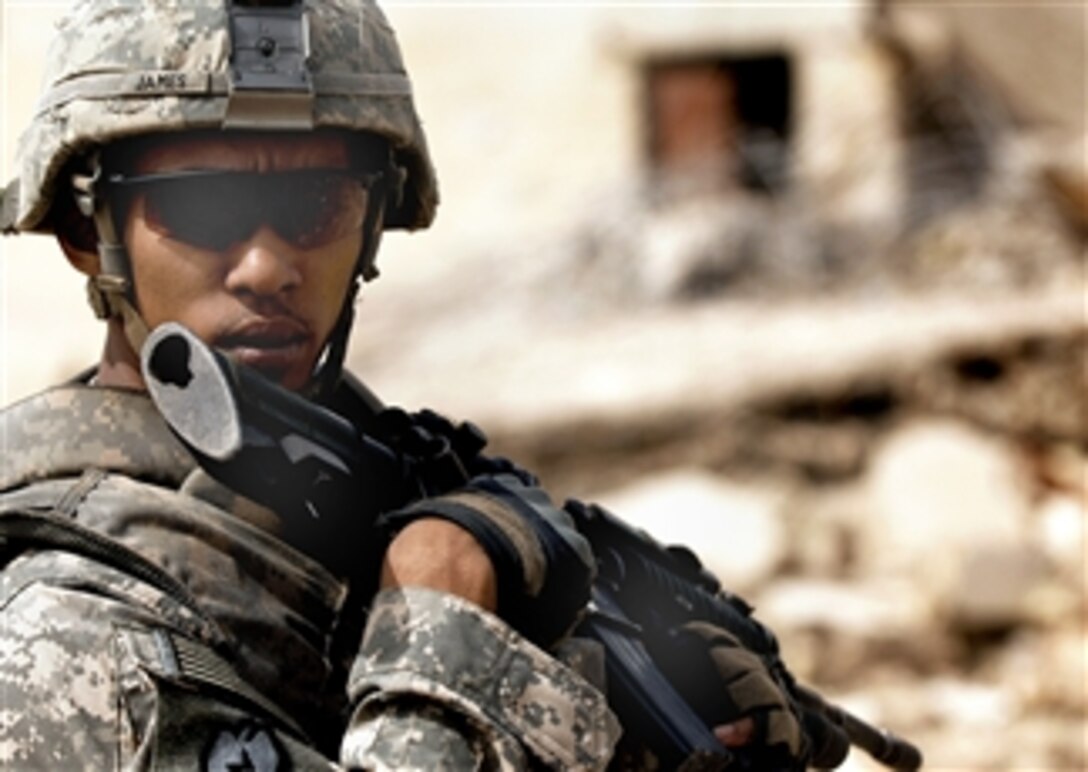 U.S. Army Sgt. Nigel James provides security as provincial reconstruction team members work near Al Raoud, Iraq, April 10, 2008. James is assigned to the 25th Infantry Division's Company C, 1st Battalion, 27th Infantry Regiment, Stryker Brigade Combat Team.