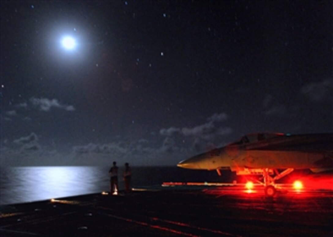 U.S. Navy sailors assigned to the Nimitz-class aircraft carrier USS Abraham Lincoln enjoy a clear night from the bow of the ship during a pause in flight operations, April 11, 2008, in the Pacific Ocean. 