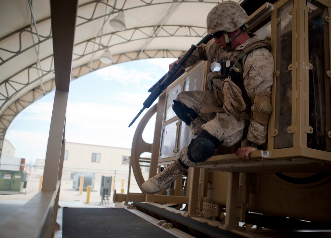 MARINE CORPS AIR GROUND COMBAT CENTER TWENTYNINE PALMS, Calif. - Cpl. Josh Stanley, Richmond Va., with Charlie Co., 4th Combat Engineer Battalion, leaps from a Mine Resistant Ambush Protected Vehicle Egress Trainer aboard Camp Wilson here July 4 during exercise Javelin Thrust 2012. Javelin Thrust is an annual large-scale exercise which allows active and reserve Marines and Sailors from 38 different states to train together as a seamless Marine Air Ground Task Force. (U.S. Marine Corps photo by Sgt. Alvin D. Parson/Released)