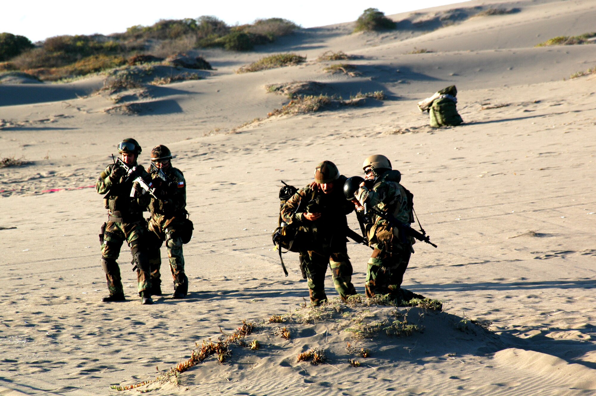 U.S. and Chilean Air Force pararescue personnel participate in a simulated casualty evacuation on the beaches of Quintero, Chile during NEWEN, a three-day combined military exercise, April 8-10.  The NEWEN exercise focused on refueling operations, search and rescue tactics and dissimilar aircraft maneuvers with members of the Chilean Air Force. (photo by U.S. Embassy- Chile)
