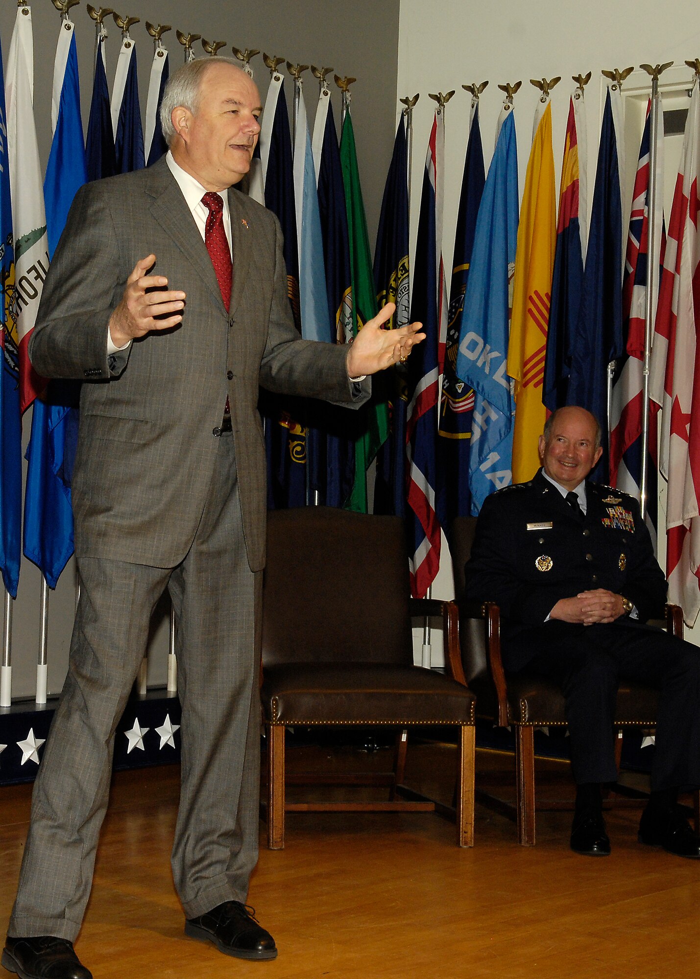 Air Force Vice Chief of Staff Gen. Duncan J. McNabb (seated) watches Secretary of the Air Force Michael W. Wynne address the audience April 14 during the Air Force Presidential Rank Awards Ceremony at Arlington National Cemetery. (U.S. Air Force photo/Donna Parry)