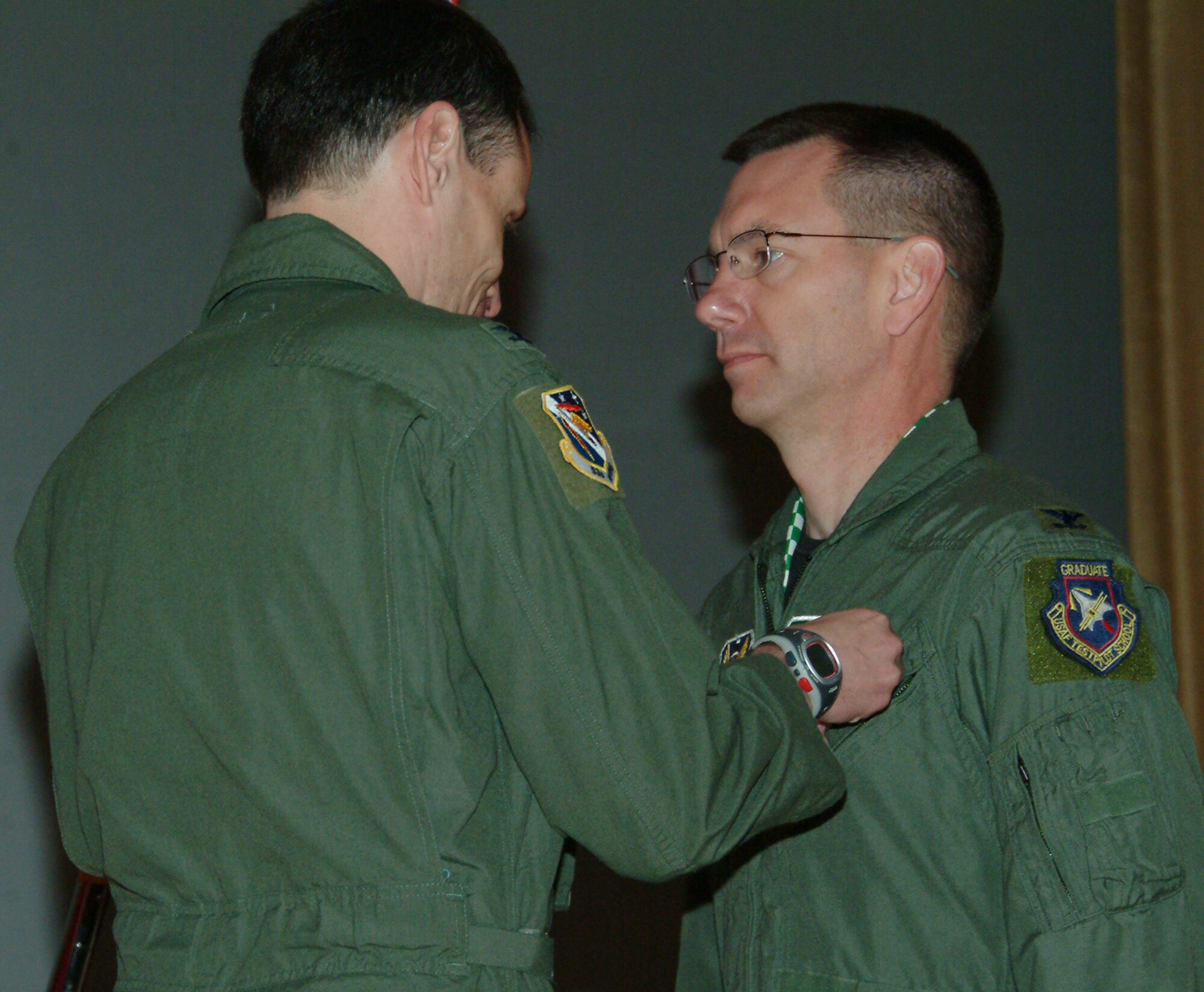 Col. Steve DePalmer, 53d Wing commander, awards Col. Dragoo, 53d Electronic Warfare Group, a bronze star April 15 at Eglin Air Force Base, Fla. during a commander's call at the base theater.  Colonel Dragoo was awarded the bronze star the NATO medal and the Afghanistan medal for his actions during his deployment in support of Operation Enduring Freedom.  Photo by Staff Sgt. Samuel King Jr.
