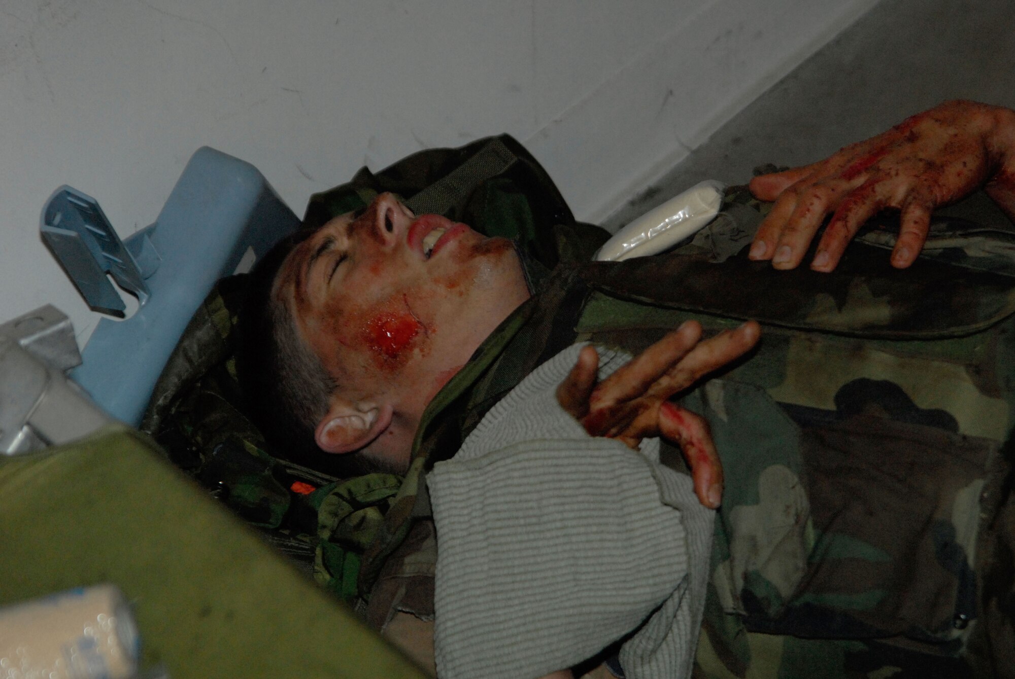 Senior Airman Joshua Crain, a member of the 189th Medical Squadron, portrays an attack casualty at the field exercise during the Air Education and Training Command Operational Readiness Inspection Apr. 9 at Camp Warlord. Some members of the 189 MDS wore moulage to simulate wounds for their fellow Airmen to treat using self aid and buddy care. (Photo by Senior Airman Julian Johnson)