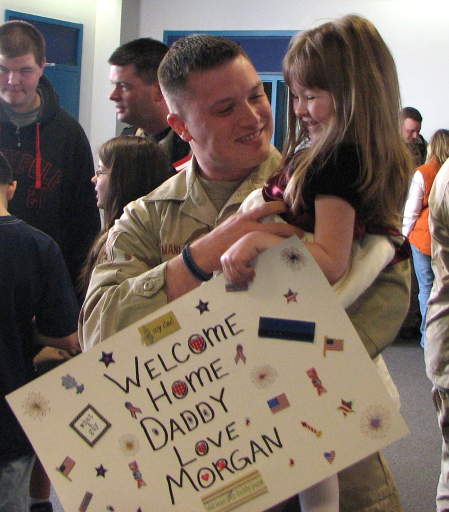 (Photo by Staff Sgt. CeeJay Garner) Staff Sgt. Stephen Manley, a Northeast Air Defense Sector Security Force member returning from deployment, smiles at his daughter Morgan at the Syracuse International Airport March 14. In the unit's largest deployment ever, nearly 30 security force members deployed on a six-month tour to Manas Air Base, located in Kyrgyzstan, in September 2007.