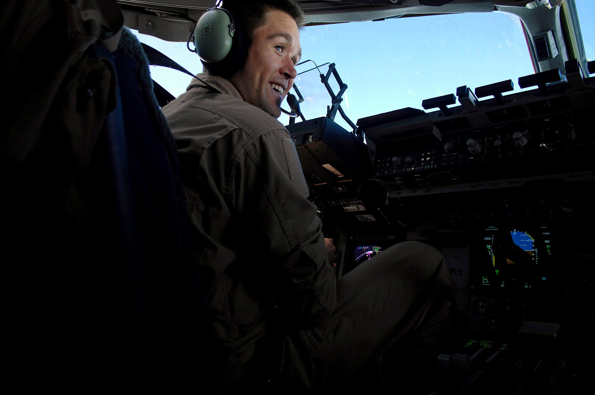 Capt. Erik Rathke talks to his co-pilot prior to the delivery of 40 bundles using the Joint Precision Airdrop Delivery System of humanitarian supplies to a drop zone April 13 in Afghanistan. Captain Rathke is a pilot from the 17th Airlift Squadron from Charleston Air Force Base, S.C., and is deployed to the 816th Expeditionary Airlift Squadron in Southwest Asia. (U.S. Air Force photo/Master Sgt. Andy Dunaway) 