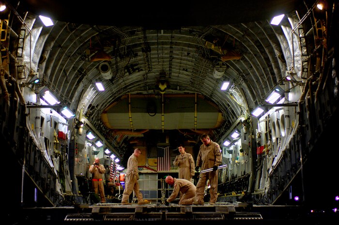 Loadmasters preflight a C-17 Globemaster III for a Joint Precision Airdrop Delivery System of 40 bundles of humanitarian supplies to a drop zone April 13 in Afghanistan. The loadmasters are from the 17th Airlift Squadron from Charleston Air Force Base, S.C., and are deployed to the 816th Expeditionary Airlift Squadron in Southwest Asia. (U.S. Air Force photo/Master Sgt. Andy Dunaway) 