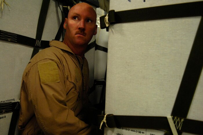 Staff Sgt. Chris Koch checks a bundle on a C-17 Globemaster III for a Joint Precision Airdrop Delivery System of 40 bundles of humanitarian supplies to a drop zone April 14 in Afghanistan. Sergeant Koch is a loadmaster from the 17th Airlift Squadron from Charleston Air Force Base, S.C., and is deployed to the 816th Expeditionary Airlift Squadron in Southwest Asia. (U.S. Air Force photo/Master Sgt. Andy Dunaway) 