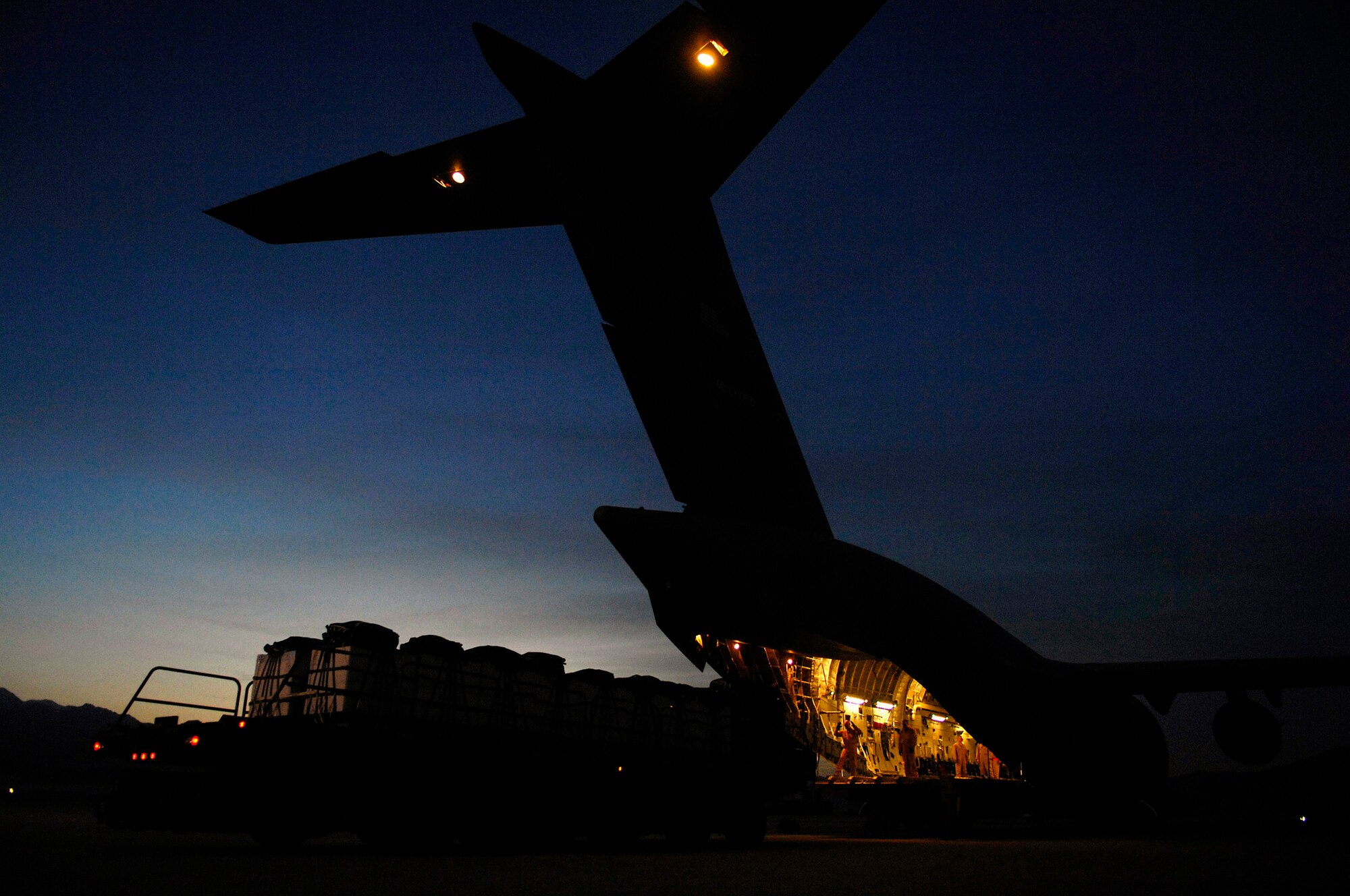 A C-17 Globemaster III is being loaded with 40 bundles for a Joint Precision Airdrop Delivery System of humanitarian supplies April 13 at Bagram Air Base, Afghanistan, for a drop zone in Afghanistan. Aircrew Airmen and the C-17 are deployed to the 816th Expeditionary Airlift Squadron in Southwest Asia. (U.S. Air Force photo/Master Sgt. Andy Dunaway) 