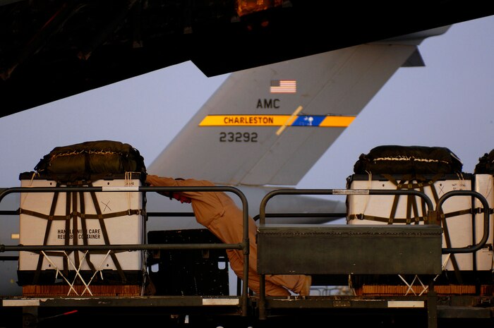Senior Airman Matt Johnson loads one of 40 bundles on a C-17 Globemaster III for a Joint Precision Airdrop Delivery System of humanitarian supplies to a drop zone April 13 in Afghanistan. Airman Johnson is from the 17th Airlift Squadron from Charleston Air Force Base, S.C., and is deployed to the 816th Expeditionary Airlift Squadron in Southwest Asia. (U.S. Air Force photo/Master Sgt. Andy Dunaway)