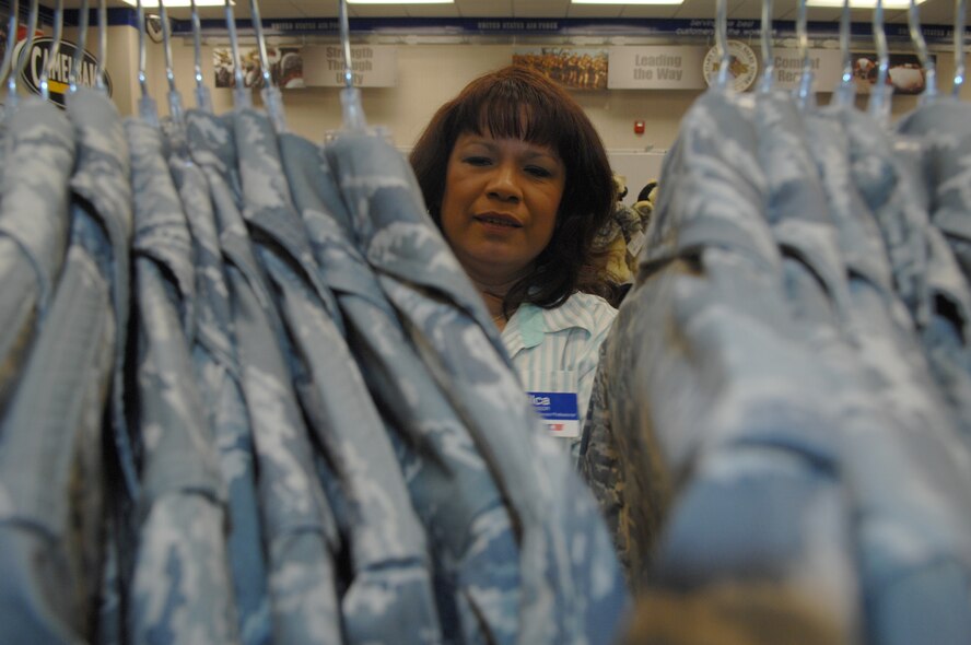 HOLLOMAN AIR FORCE BASE, N.M. -- Milca Stevens, Military Clothing Sales manager, reorganizes the maternity Airman Battle Uniform blouses, here April 15. (U.S. Air Force photo/ Senior Airman Anthony Nelson Jr)