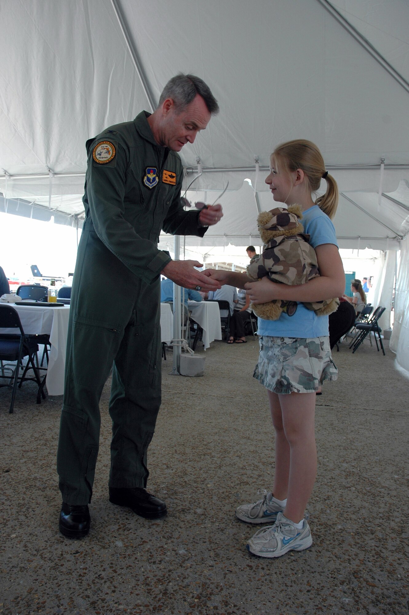 Bailey Reese, founder and president of Hero Hugs, meets Col. Darryl Roberson, 325th Fighter Wing commander, during the recent open house at Tyndall Air Force Base, Fla.  Bailey, with the help of her family, started Hero Hugs four years ago to recognize and show appreciation for America's servicemembers.  (U.S. Air Force photo/Staff Sgt. Vesta M. Anderson)