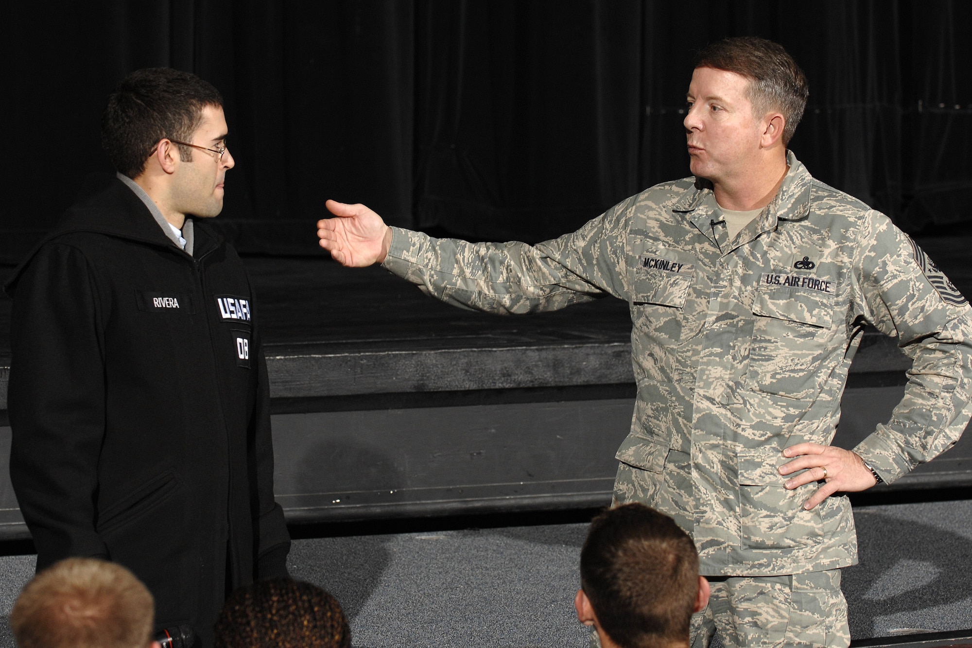 Chief Master Sgt. of the Air Force Rodney J. McKinley talks with Cadet 1st Class Michael Rivera during a cadet call held April 10 in Arnold Hall at the U.S. Air Force Academy in Colorado. Chief McKinley visited Academy Airmen to brief on the Air Force's top priorities. Cadet Rivera is assigned to Cadet Squadron 25 at the Academy. (U.S. Air Force photo/Rachel Boettcher)
