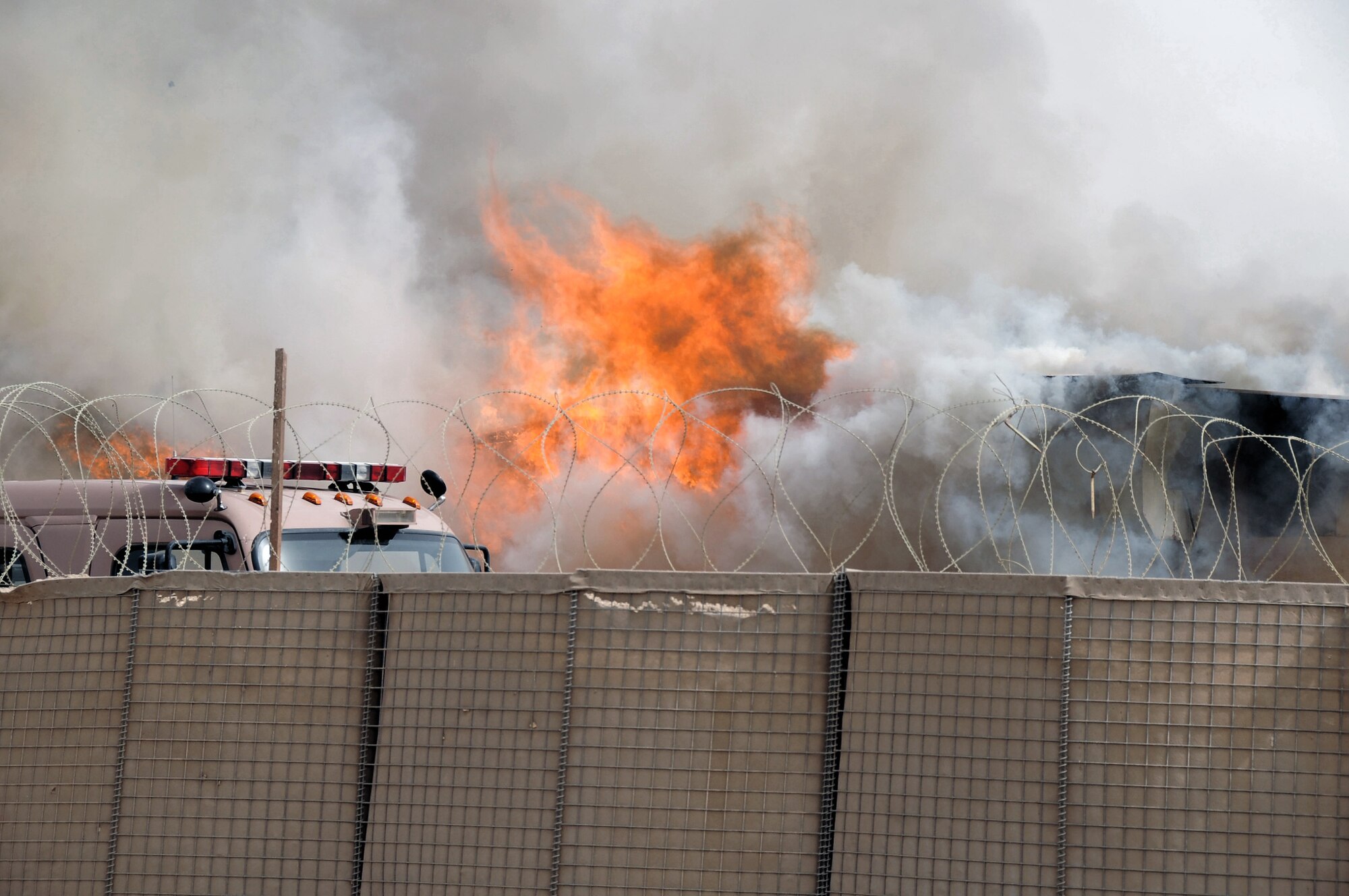 The 407th Expeditionary Civil Engineering Squadron firefighters repond to a blazing building in the Romanian camp April 11 at Ali Base, Iraq. The Air Force emergency response forces respond to all emergencies here including coalition partners. The building was destroyed but there were no casualties. (U.S. Air Force photo/Tech. Sgt. Sabrina Johnson) 
