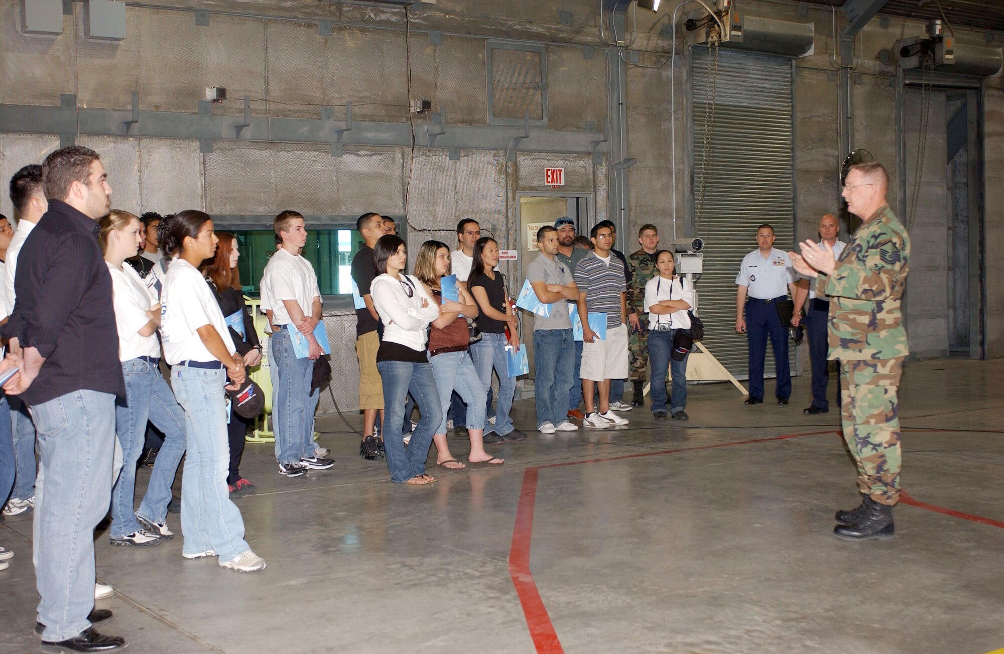 Master Sgt. Mark Franklin (right) explains how the hush houses on base help the wing safely and quietly test F-16 engines. The recruiting effort successfully showcased several job opportunities for the 25 ‘buddies’ that participated April 5. Three of the visitors initiated the enlistment process that very day, and several others asked recruiters to follow up with them. (Air National Guard Photo by Senior Airman Sarah Flint)