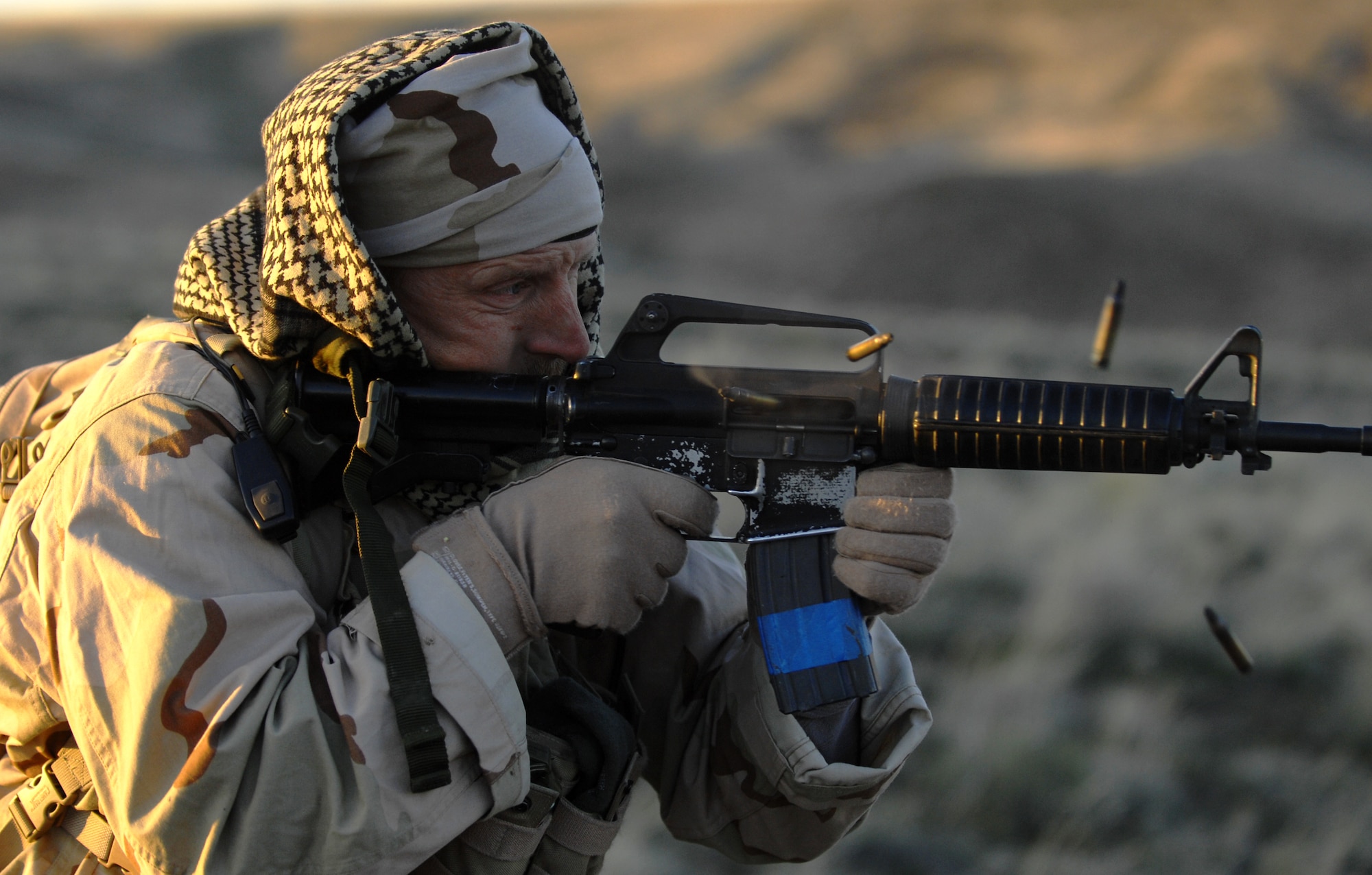 MOUNTAIN HOME AIR FORCE BASE, Idaho-- Tech. Sgt. Robert Singleton, 366th Security Forces instructor, fires blanks from his M-16 rifle in the direction of hidden aircrews as they attempt to move through Saylor Creek Range to safety during an aircrew training course April 10. Sergeant Singleton is acting as an opposing enemy force who the aircrews are trying to evade. Aircrews are required to update their combat survival training ever 36 months to be proficient in the event that they have to eject behind enemy lines and evade capture. (U.S. Air Force photo/ Airman 1st Class Ryan Crane) 