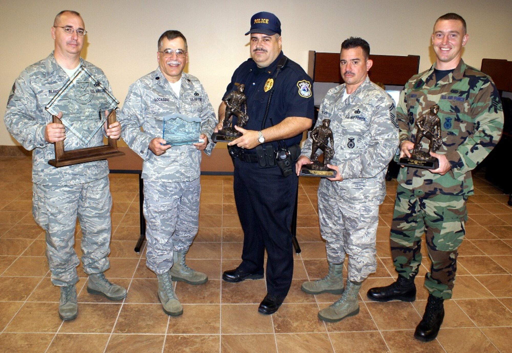 Chief Master Sgt. Michael Blake, Lt. Col. Frank Locascio, Juan Lemus, Senior Master Sgt. Wilfredo Vargas and Senior Airman Sergio Greco hold up accolades garnered by the 482nd Security Forces Squadron for 2007. The Air Force selected the 482nd Security Forces Squadron as its best security forces reserve unit for 2007. The squadron won for best in the Air Force Reserve Command; Senior Master Sgt. Wilfredo Vargas won the full-time senior non-commissioned officer category; Mr. Juan Lemus won the full-time civilian category; and Senior Airman Sergio Greco won the Elizabeth Jacobson Award for outstanding war-fighting contributions of first term Airmen. (U.S. Air Force photo)