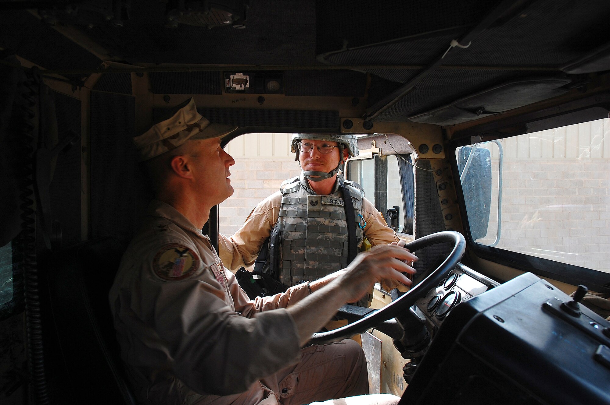 SOUTHWEST ASIA -- Staff Sgt. William Stock, a vehicle operator deployed to the 586th Expeditionary Logistics Readiness Squadron, 424th Medium Truck Detachment, explains some of the components inside of M915A3 tractor-trailer truck to Maj. Gen. Douglas Raaberg, selected for reassignment as Deputy Combined Forces Air Component Commander, U.S. Central Command, April 14, 2008, during a visit to an air base in the Persian Gulf Region. Major Gen. Maurice Forsyth, the current DCFACC, and General Raaberg are visiting Airmen throughout the area of responsibility as part of an orientation trip and to get a first-hand look at Airmen accomplishing a variety of different mission sets supporting the Global War on Terrorism. Sergeant Stock is deployed from the 92nd Logistics Readiness Squadron, Fairchild Air Force Base, Wash. (U.S. Air Force photo/ Staff Sgt. Patrick Dixon) 