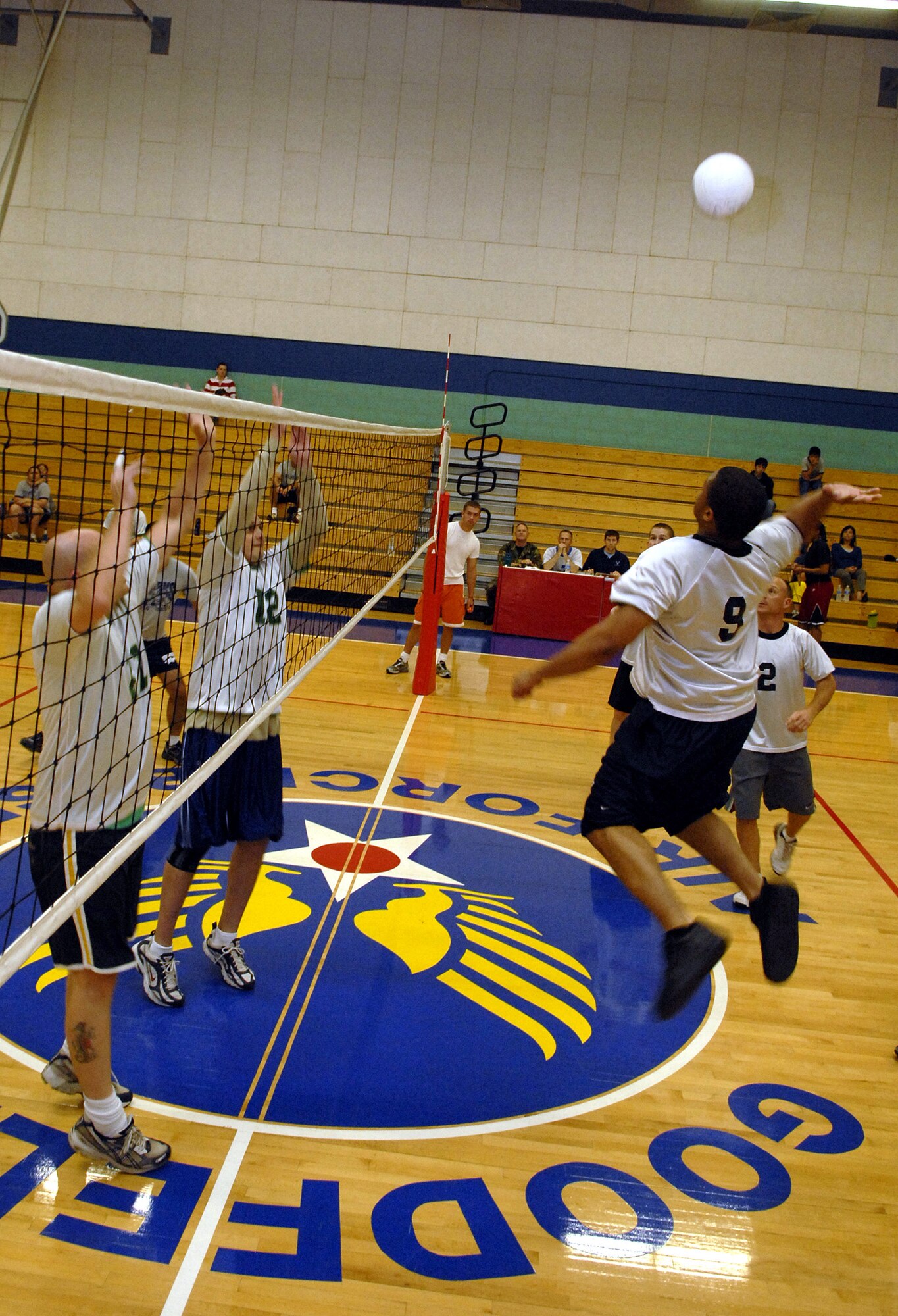 Members of the 315th Alpha Rattlers go up for a block against Airman 1st Class Leverne Jackson during the semi-final game.  (U.S. Air Force photo by Senior Airman Kamaile Chan)