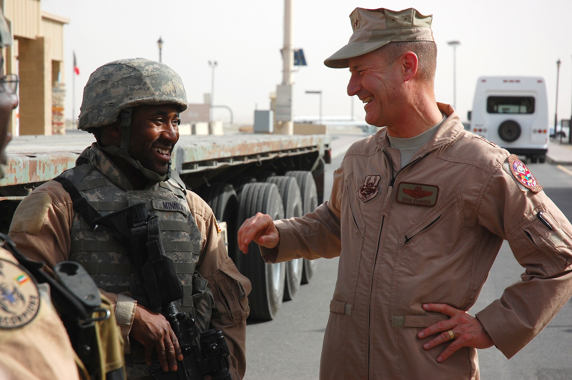 SOUTHWEST ASIA -- Staff Sgt. Darnelle Minnick, a vehicle maintainer deployed to the 586th Expeditionary Logistics Readiness Squadron, 70th Medium Truck Detachment, shares a laugh with Maj. Gen. Douglas Raaberg, selected for reassignment as Deputy Combined Forces Air Component Commander, U.S. Central Command April 14, 2008, during a visit to an air base in the Persian Gulf Region. Major Gen. Maurice Forsyth, the current DCFACC, and General Raaberg are visiting Airmen throughout the area of responsibility as part of an orientation trip and to get a first-hand look at Airmen accomplishing a variety of different mission sets supporting the Global War on Terrorism. Sergeant Minnick is deployed from the 437th Logistics Readiness Squadron, Charleston Air Force Base, S.C. (U.S. Air Force photo/ Staff Sgt. Patrick Dixon) 