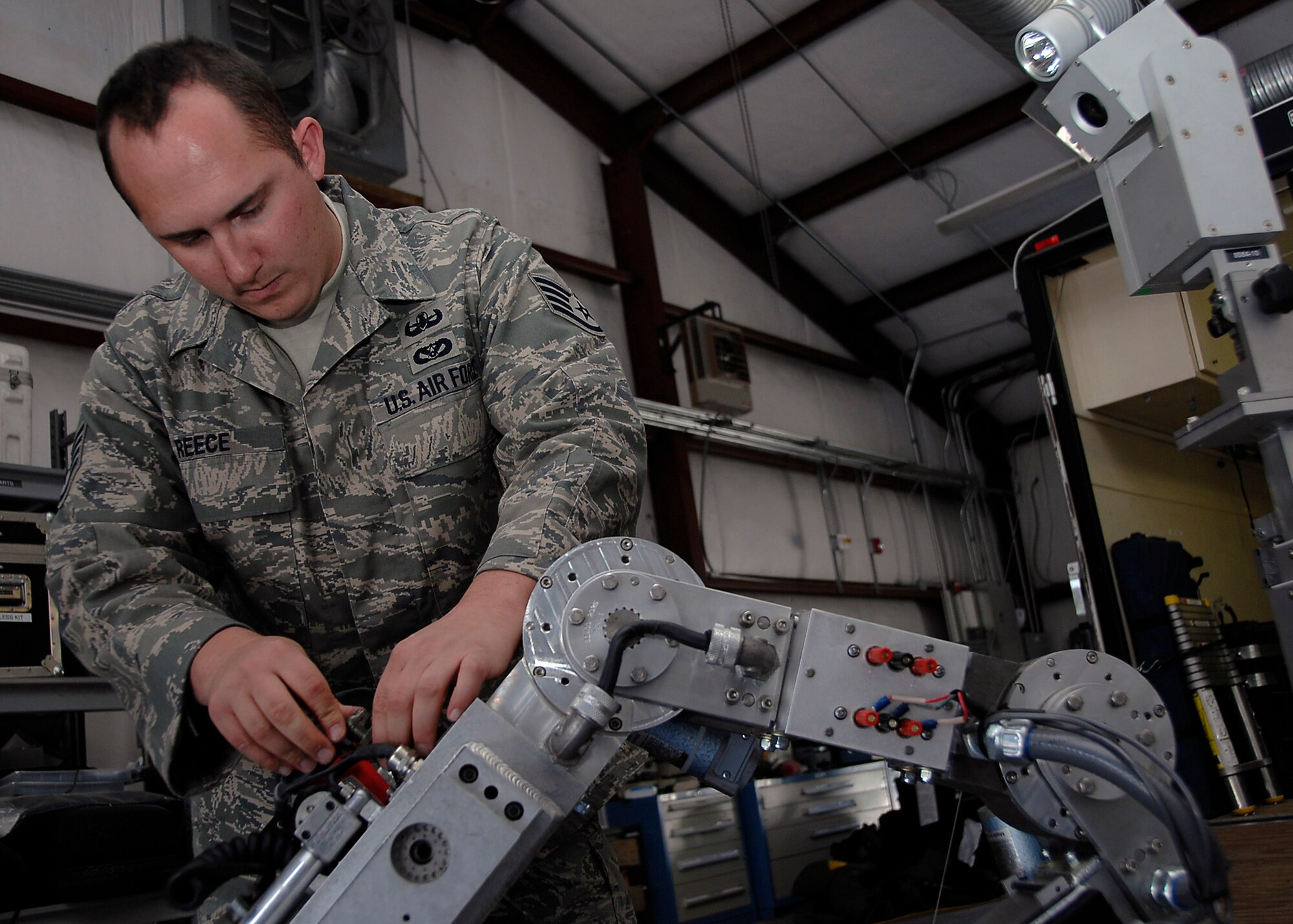 Staff Sgt. Matthew Reece tightens down a tool on a robot during a training exercise on Charleston AFB Sunday. Explosive ordnance disposal Airmen train so they can be proficient during disposal of explosive devices.   Sergeant Reece is an EOD technician for the 315th Airlift Wing.  (U.S. Air Force photo/Airman 1st Class Katie Gieratz)

