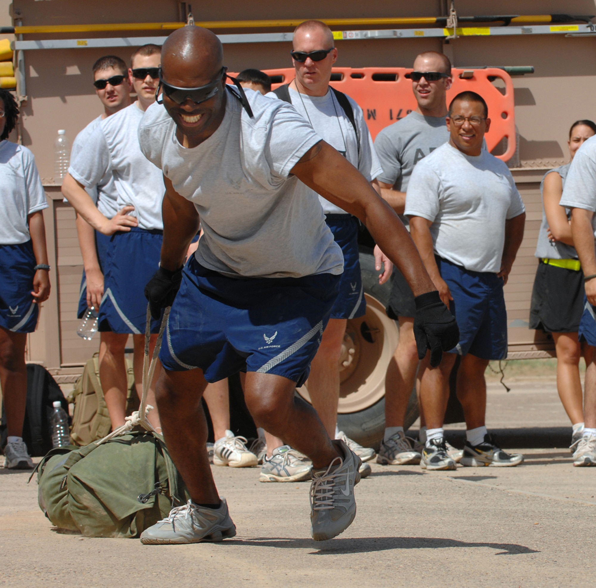 BALAD AIR BASE, Iraq ? Tech. Sgt. Harold Joe, 332nd Air Expeditionary Wing ground safety technician, pulls a 75-pound bag, simulating a person?s body weight, during the firefighter challenge event at the fire muster here, April 13. The fire muster was a community event hosted by the 332nd Expeditionary Civil Engineer Squadron firefighters to demonstrate what it takes to be a firefighter on a day-to-day basis. The six different events challenged the 20, six-member teams who competed. Sergeant Joe is deployed from Dover Air Force Base, Del. (U.S. Air Force photo/ Senior Airman Julianne Showalter)