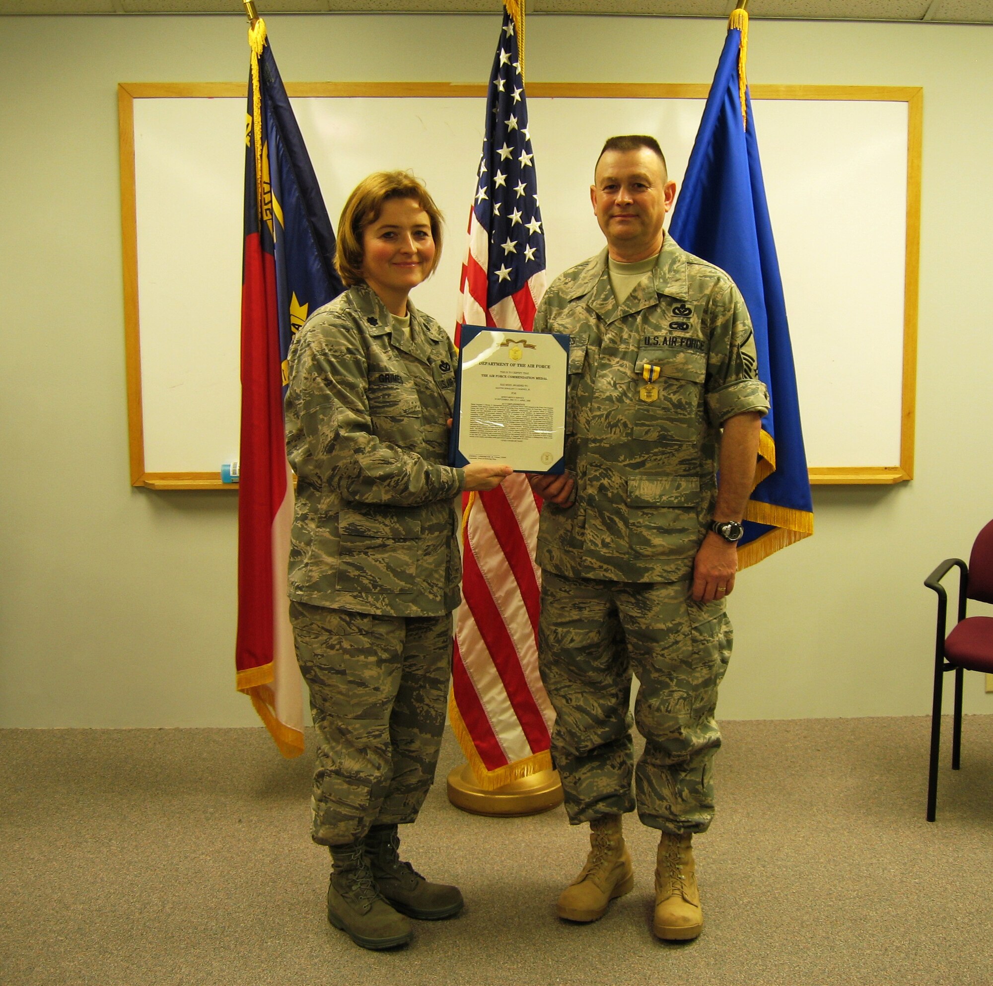 SEYMOUR JOHNSON AIR FORCE BASE, N.C. -- Master Sgt. E.J. Barnes, Jr. (right) receives the Air Force Commendation Medal from his commander, Lt. Col. Kerri Grimes, during his retirement ceremony during the April unit training assembly. Sgt. Barnes served 26 years and retired as an operations management technician with the 916th Civil Engineer Squadron.