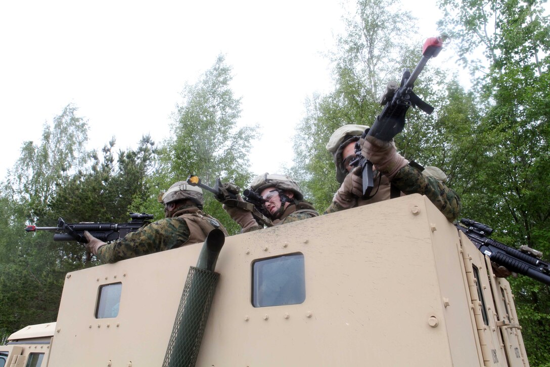 ADAZI, Latvia (June 11, 2012) -- Marines of Kilo Company, 3rd Battalion, 25th Marine Regiment aim their sights during convoy operations excercise at Saber Strike. The troops worked with the Estonian Army to strengthen their relationship between them and other nations. Saber Strike is a USAREUR-led theater security operatin conducted in the Batic States of Estonia, Latvia and Lithuana. (U.S. Marine Corps photo by Sgt. Ray Lewis)::r::::n::