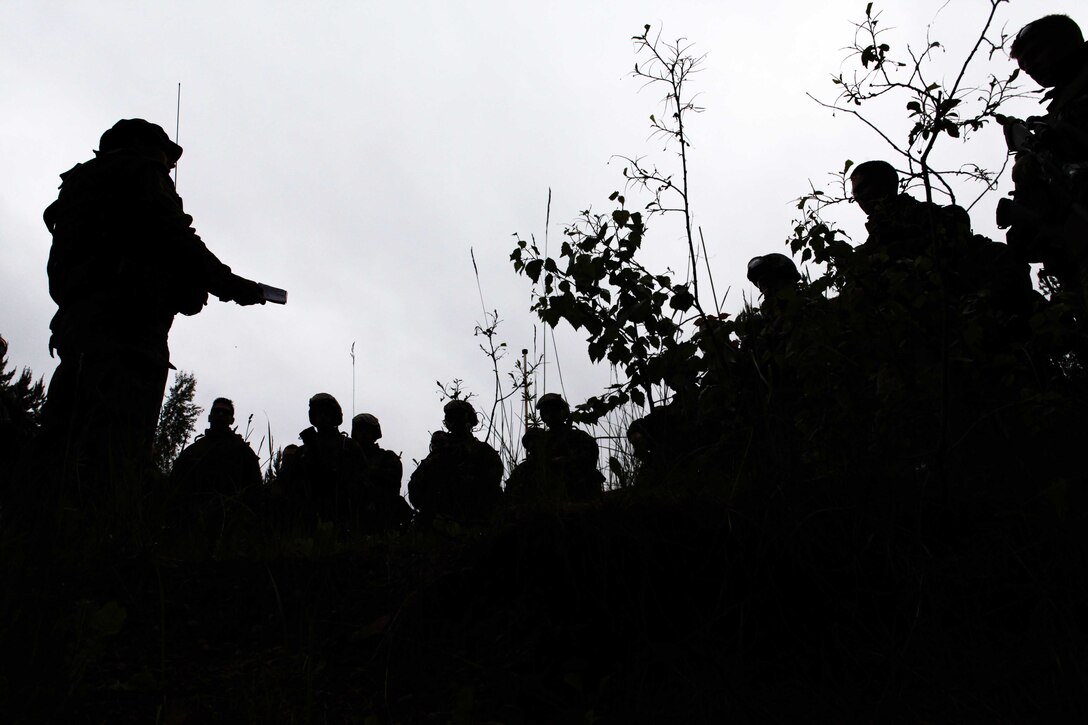 ADAZI, Latvia (June 11, 2012) -- Estonian Army 1st Lieutenant Denis Borzeniw debriefs the Marines of Kilo Company, 3rd Battalion, 25th Marine Regiment after a convoy operations excercise during Saber Strike. The officer gave the Marines a critique on the job they did while the excercise was in session. Saber Strike is a USAREUR-led theater security operatin conducted in the Batic States of Estonia, Latvia and Lithuana. (U.S. Marine Corps photo by Sgt. Ray Lewis)