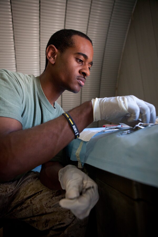 Petty Officer 3rd Class Nathaniel Peterson, Atlanta, attached to 4th Dental Bn., 4th Dental Company, separates dental sterilization instruments at exercise Javelin Thrust 2012. Javelin Thrust is an annual large-scale exercise here which allows active and reserve Marines and sailors from 38 different states to train together as a seamless Marine Air Ground Task Force.