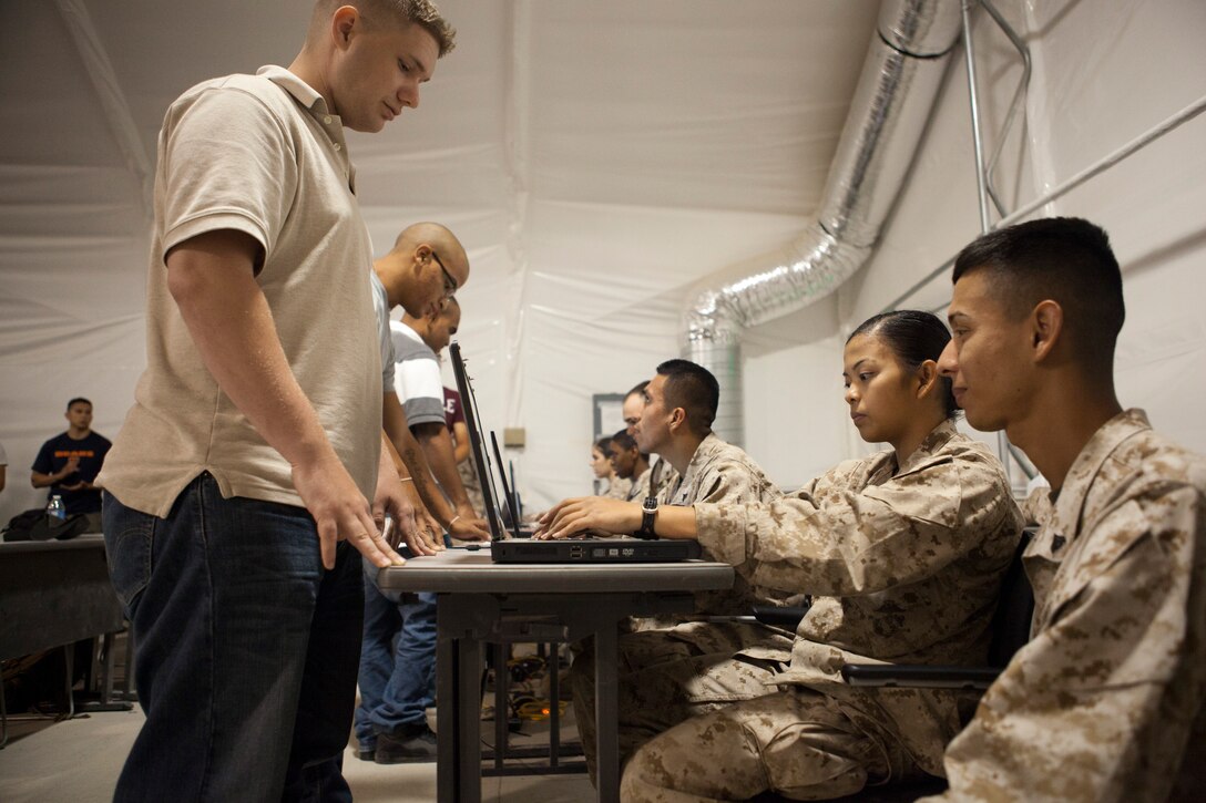 Lance Cpl. Mary Ababat, Corona, Calif., and Cpl. Juan Topete, San Diego, Calif., join reserve Marines and Sailors into exercise Javelin Thrust at the Joint Reception Center of Camp Wilson July 5, 2012. Javelin Thrust is an annual large-scale exercise here which allows active and reserve Marines and sailors from 38 different states to train together as a seamless Marine Air Ground Task Force.