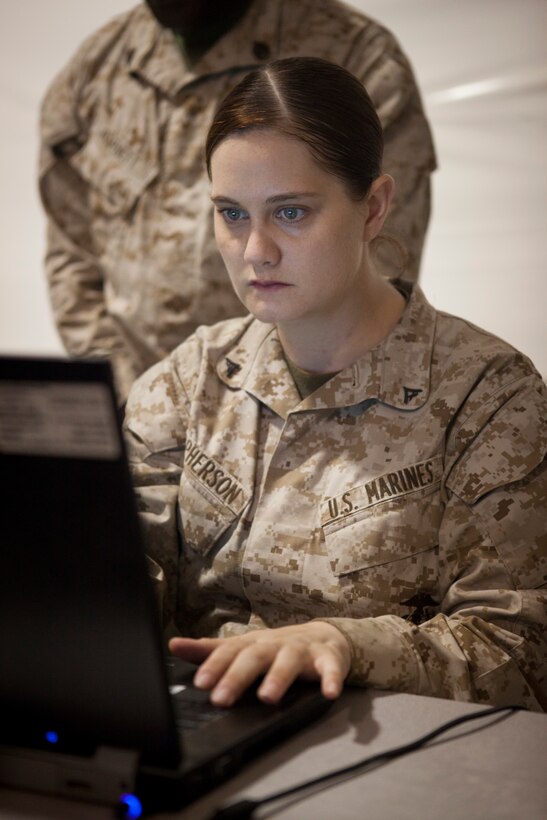 Lance Cpl. Elizabeth McPherson, Elizabeth, N.C., with 4th Supply Battalion, joins reserve Marines and Sailors into exercise Javelin Thrust at the Joint Reception Center of Camp Wilson July 5, 2012. Javelin Thrust is an annual large-scale exercise here which allows active and reserve Marines and sailors from 38 different states to train together as a seamless Marine Air Ground Task Force.