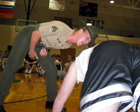 Drill Instructor Sgt. Beth Abbott runs more than 100 Michigan poolees from RSSs Kalamazoo and Battle Creek through basic physical training exercises during a Family Night event April 16. Abbot is assigned to 4th Recruit Training Battalion, Oscar Company, at Marine Corps Recruit Depot Parris Island, S.C.