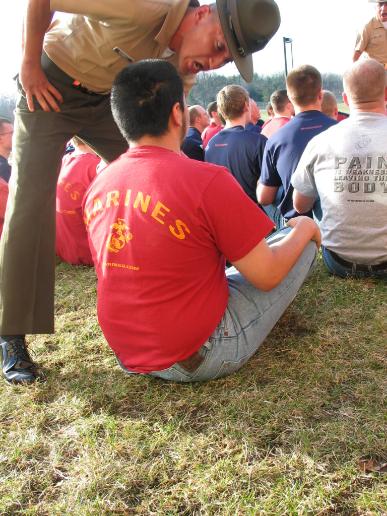 Drill Instructor Sgt. Edgar Ramirez (left) teaches the poolees of Recruiting Substations Kalamazoo and Battle Creek that you "don't ever touch your face," while Drill Instructor Staff Sgt. Damian Rodriguez teaches the poolees how to get in formation during Family night April 16. Three drill instructors talked to the parents and poolees about the transformation their sons or daughters would go through during their 13 weeks in recruit training.