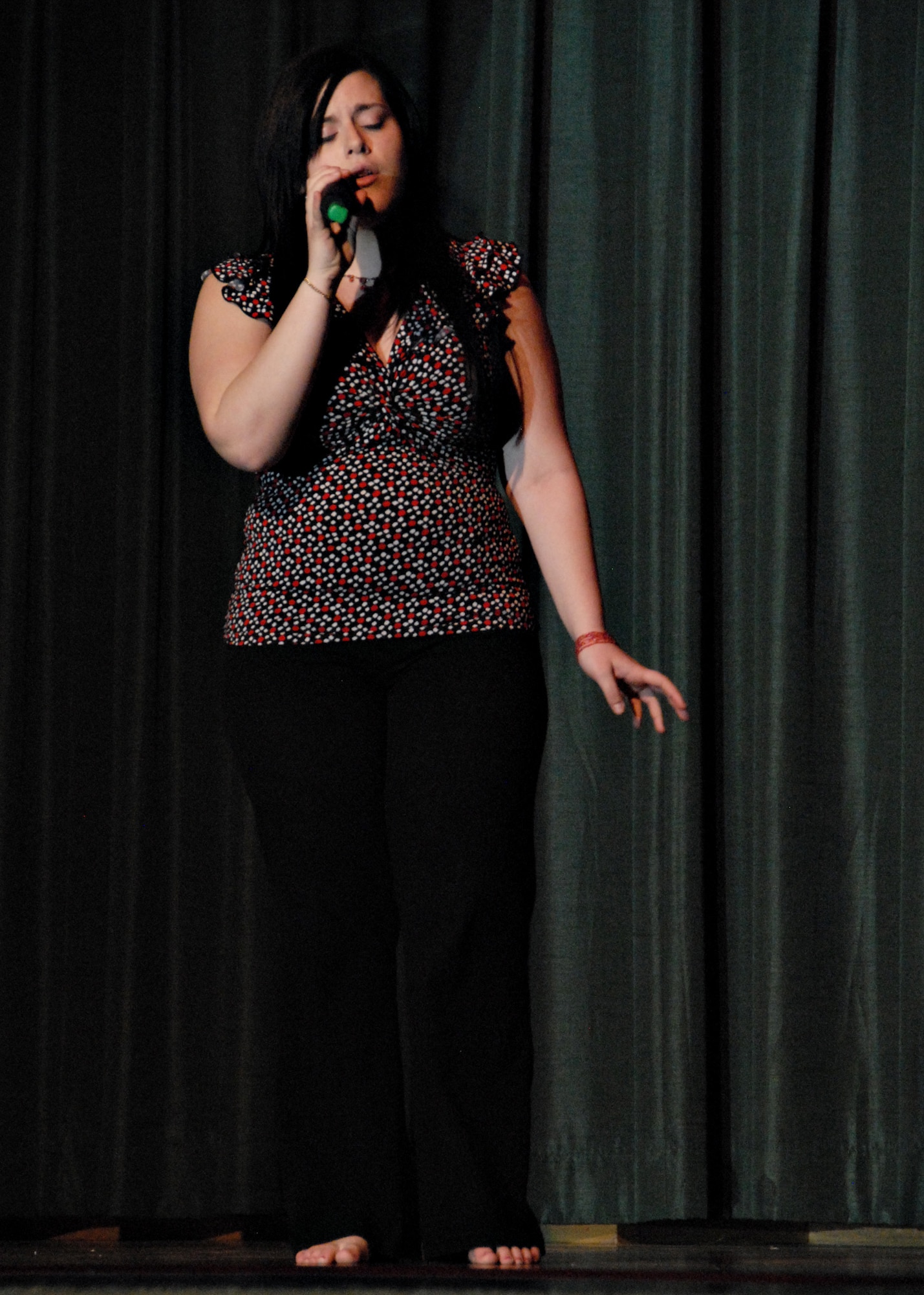 MISAWA AIR BASE, Japan -- Laura Pumarejo sings Joss Stone's "Right to be Wrong" a cappella and barefoot during the first round of Misawa Idol held April 5, 2008. Ms. Pumarejo will advance to the next round and perform on April 19 at the enlisted club. (U.S. Air Force photo by Staff Sgt. Rachel Martinez)
