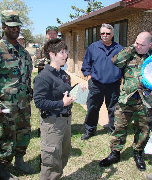 Special Agent Jennifer Steel, an Air Force Office of Special Investigations forensic science consultant, reviews a practical exercise April 15 with people from bioenvironmental, AFOSI, security forces and the fire department at Vance Air Force Base, Okla., on how to preserve and process a chemical or weapon-of-mass-destruction scene that may be a result of criminal activity. (U.S. Air Force photo/Capt. Tony Wickman)