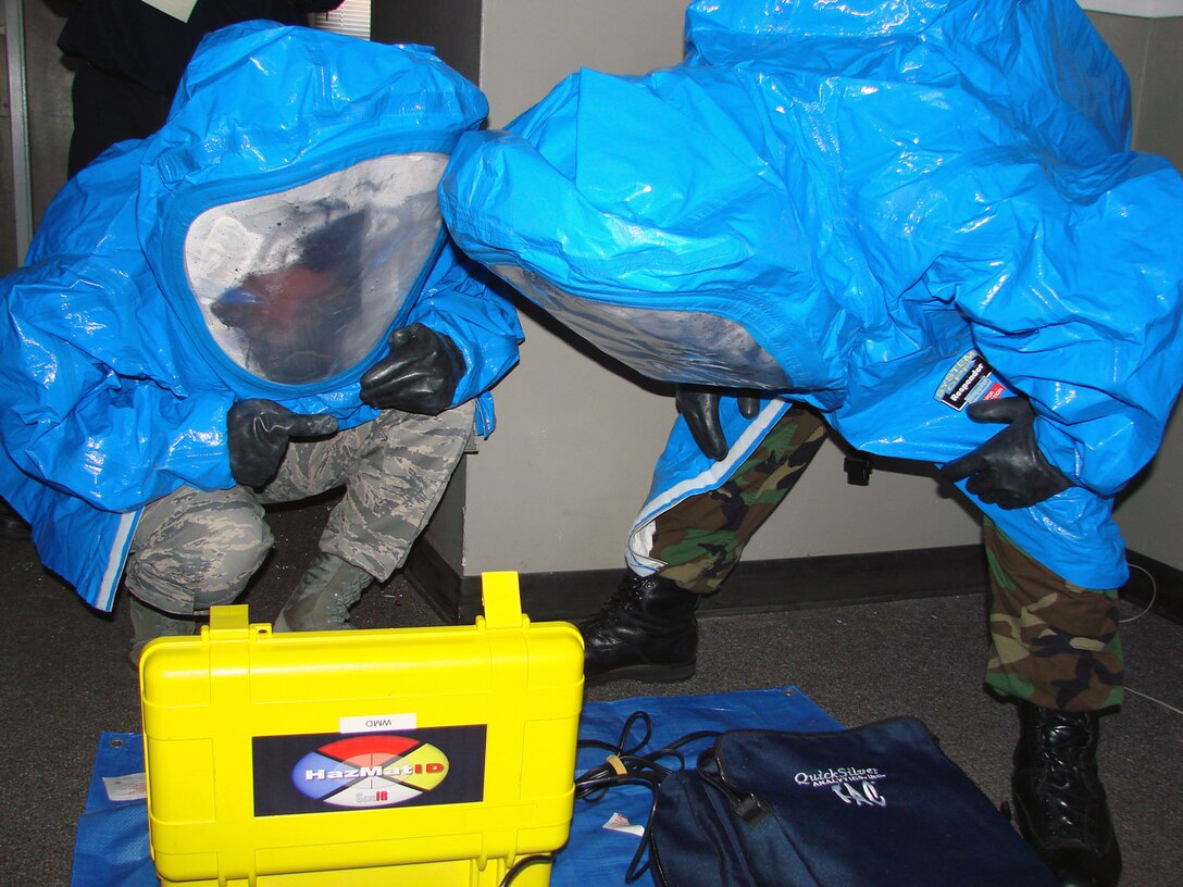 Airman 1st Class Justin Barajas, 71st Medical Group bioenvironmental engineering, and Senior Airman Brock Evans, 71st Logistics Readiness Squadron civil engineering readiness, practice taking and analyzing samples during training April 15 at Vance Air Force Base, Okla., on how to process a hazardous materials incident.  The training was provided by an Air Force Office of Special Investigations crime scene investigator. (U.S. Air Force photo/Capt. Tony Wickman)