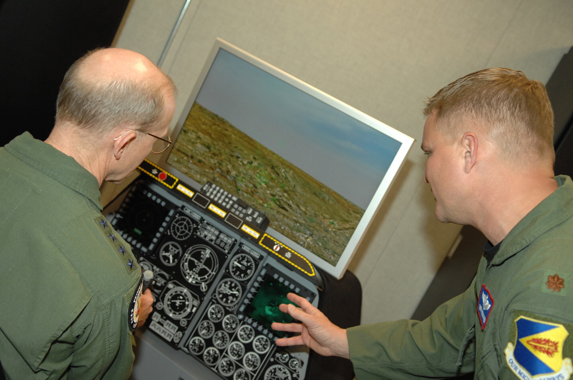 Gen. John Corley, Air Combat Command commander, uses a flight simulator as Maj. Todd Henninger, 355th Training Squadron, provides guidance during his visit to Davis-Monthan April 15. (U.S. Air Force photo/Airman 1st Class Noah R. Johnson)