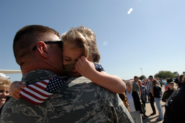 1st Lieutenant Mark Lee embraces his daughter Abigaile on the flight line of Barksdale AFB, La. Lt. Lee was deployed for eight months in support of Operation Iraqi Freedom with the 307th Red Horse Squadron. The U.S. Air Force Reserve Red Horse Squadron provides civil engineer support to forward operating bases located throughout Iraq, Apr. 13, 2008.(U.S. Air Force photo by TSgt Laura K. Smith) (released)   